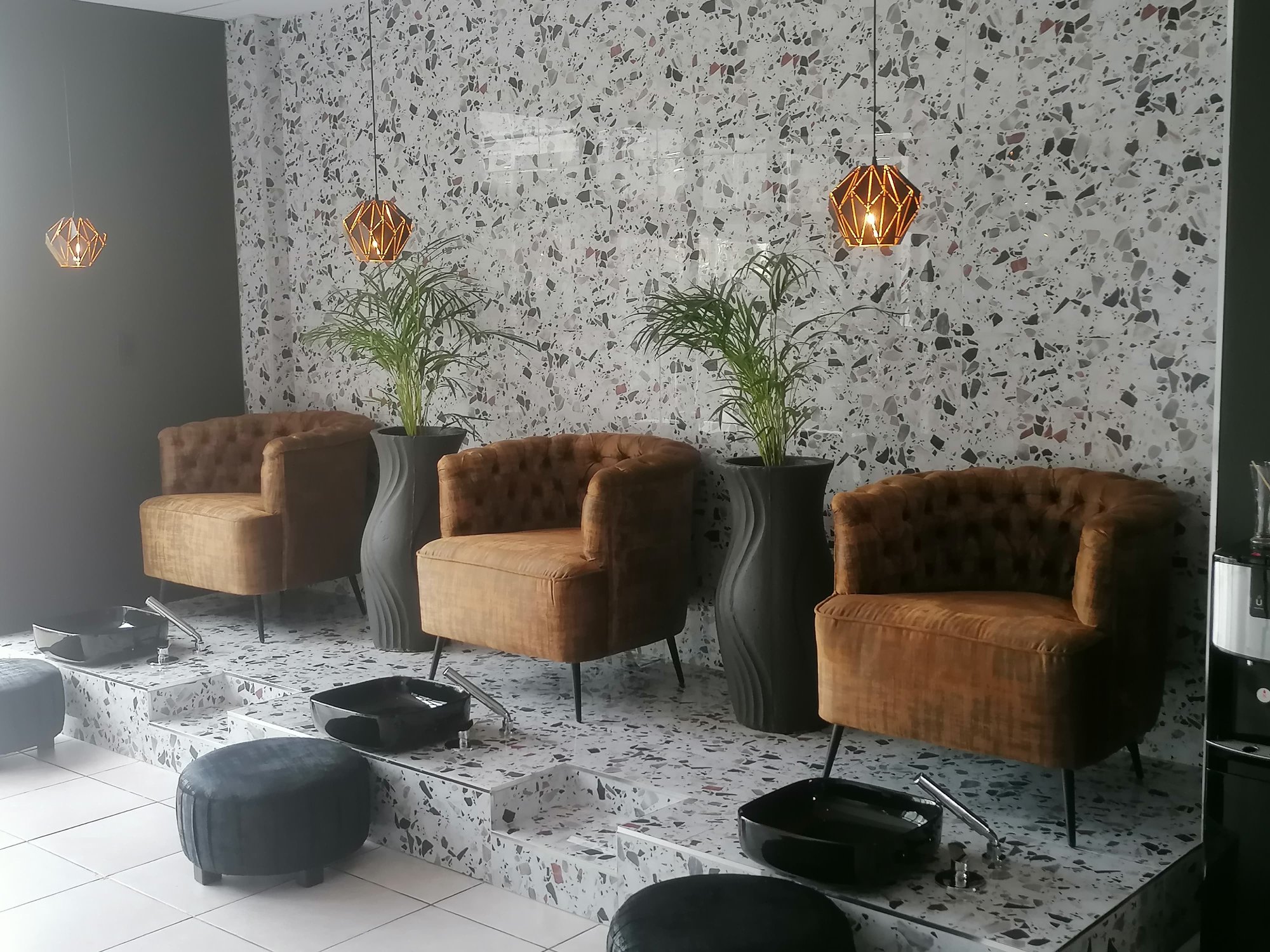 Pedicure chairs side view with golden pendant lights